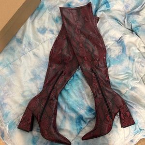 Steve Madden knee high red snake boot.